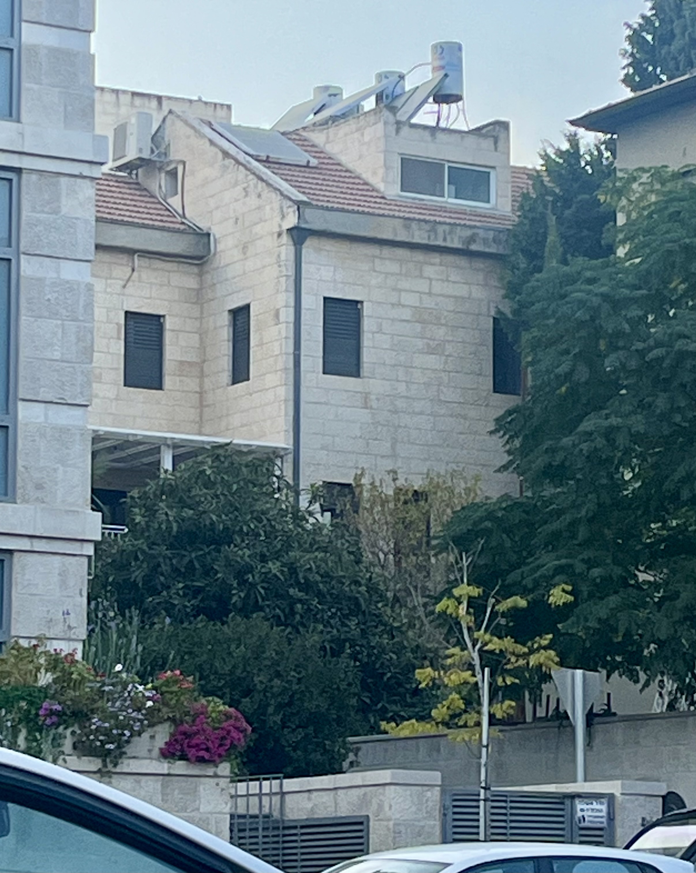 View of our apartment and the upstairs studio from across Hapalmach at Pizza May