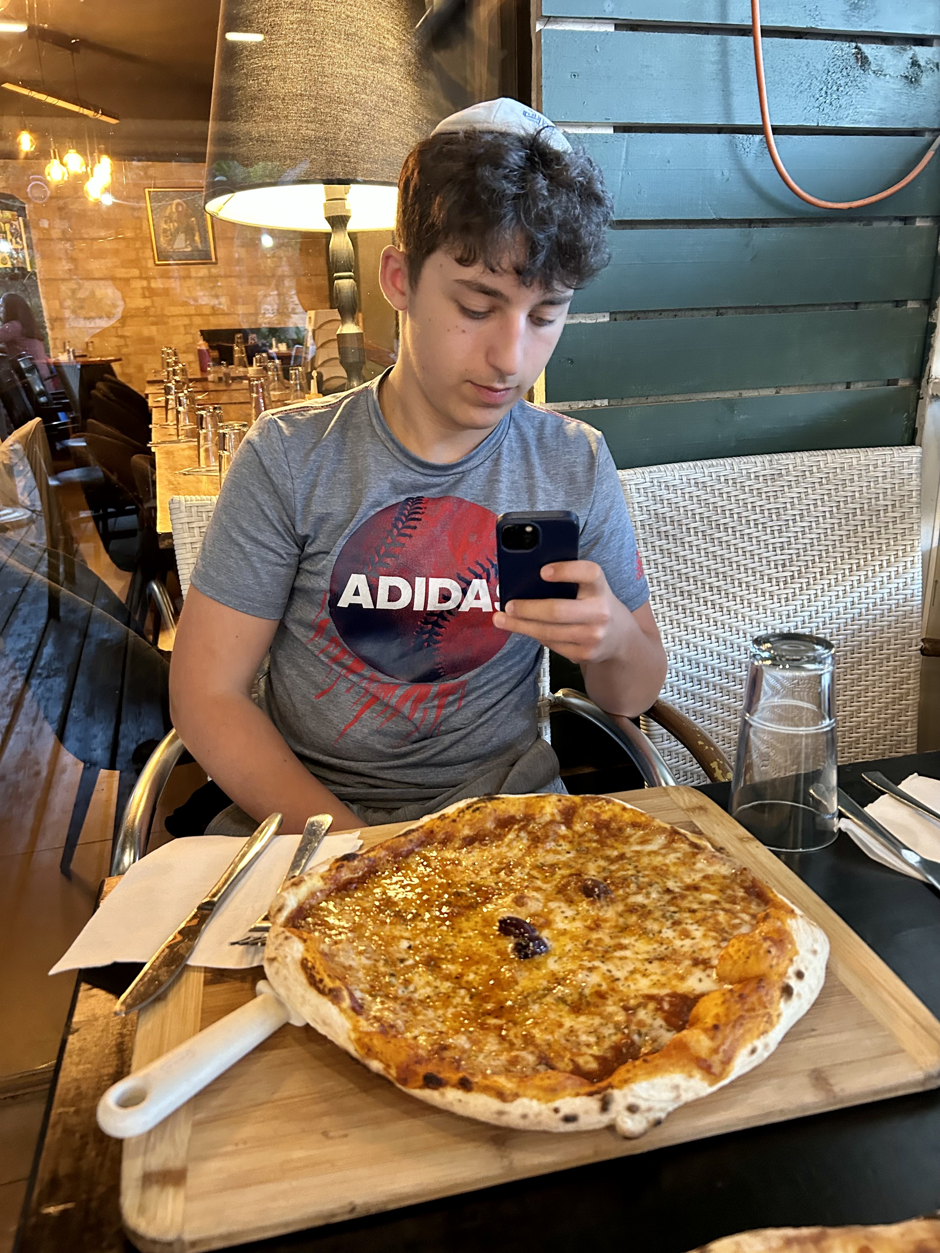 Moshe and Jonathan try pizzas at Rendez-Vous in Baka