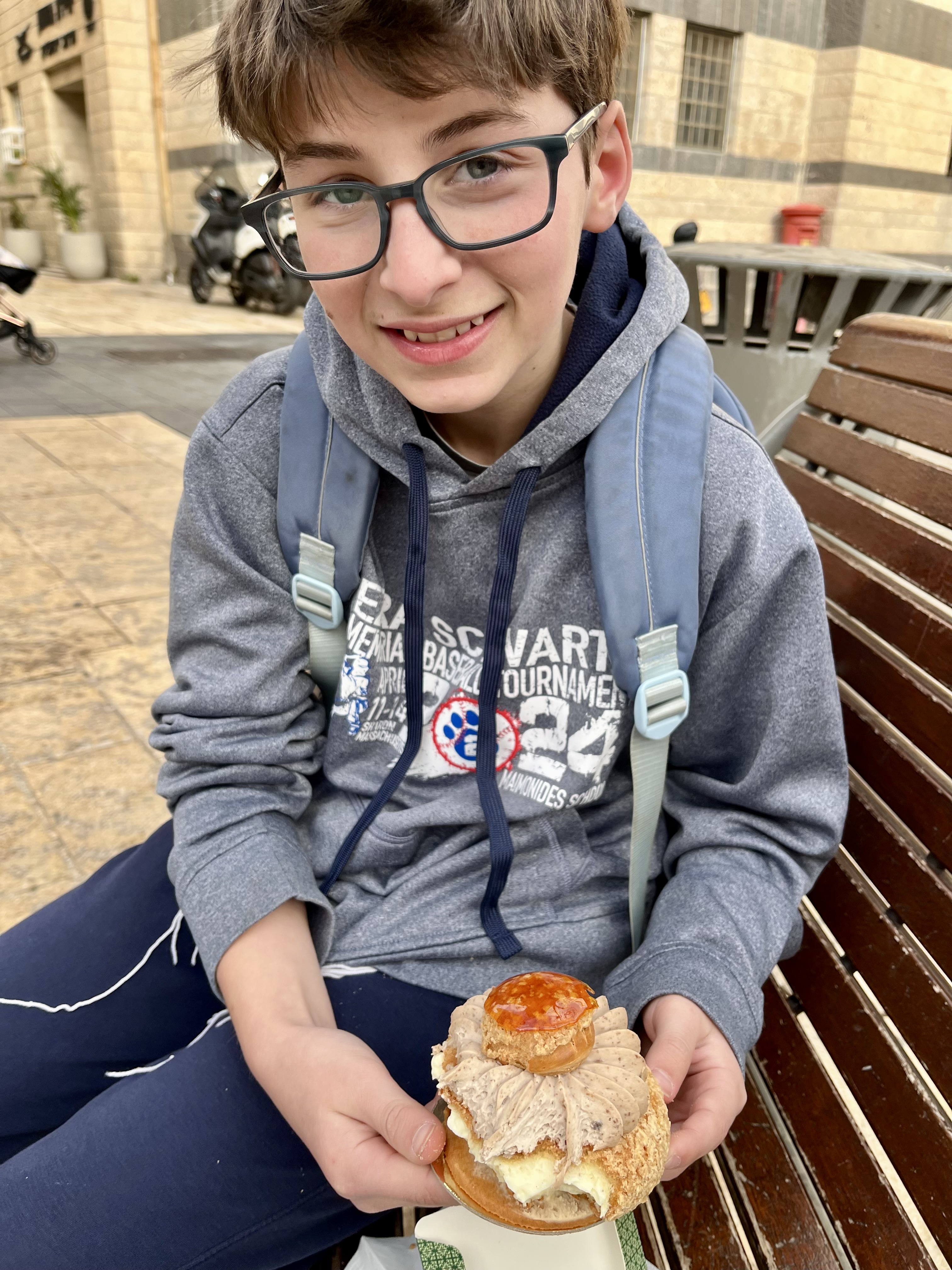 Enjoying a pastry from Kadosh while waiting for our appointment at Misrad Hapnim