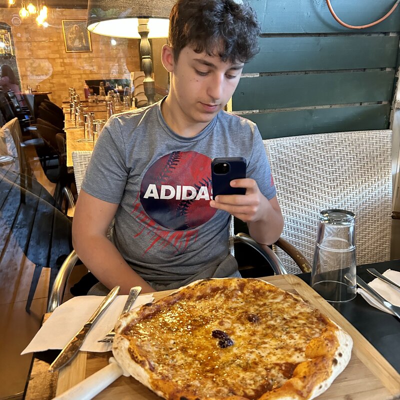 Moshe and Jonathan try pizzas at Rendez-Vous in Baka